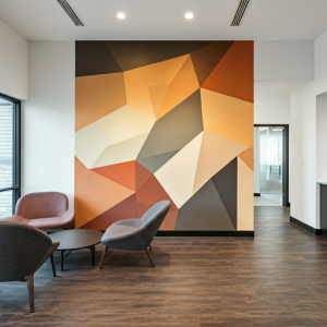 Geometric mural in warm colours in a modern office lobby