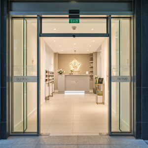 beauty and hair salon hair salon entrance at ground level, with automatic doors and a wide, level pathway leading to the reception area