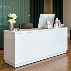 A multi-functional desk serves as a salon reception area, retail display, and even a workspace for staff.