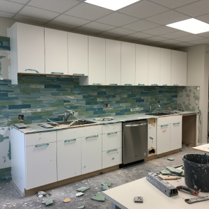 Finishing the kitchen walls with tiles.