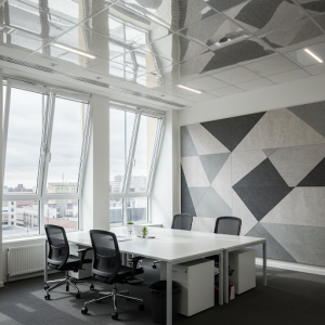 Office makeover with window expansion, highly reflective ceiling tiles, and wall panels with attractive designs help to let in maximum natural light flow.