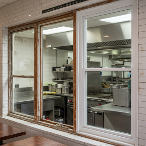 Replacement of old windows with new ones in a restaurant kitchen.