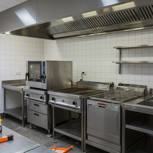 The oven, grill, fryer, and dishwasher are sourced and installed by kitchen contractors.