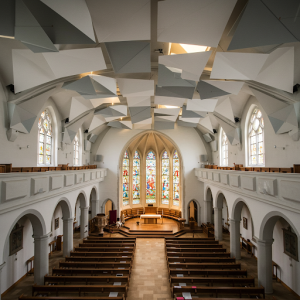 Acoustic ceiling baffles are arranged to create visually appealing patterns while improving the church's acoustics.