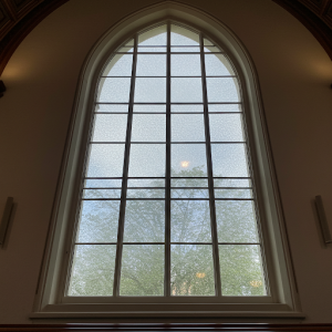 Soundproof window in a church, with multiple panes and acoustic glazing.