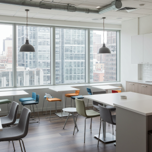 tables and furniture placed next to the office kitchen window.