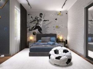 A modern boy's bedroom with a soccer theme wallpaper.